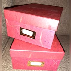 two pink boxes stacked on top of each other