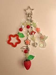 a keychain with charms attached to it on a white surface and a star in the background