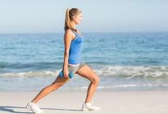 a woman is running on the beach near the ocean