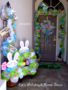 a front door decorated for easter with bunny decorations