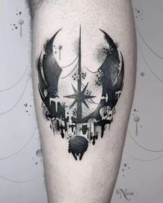 a man's leg with a black and white tattoo design on the calf area