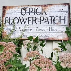 a sign that says pick flower patch in front of some flowers