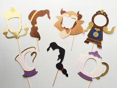 a group of paper cutouts that are sitting on top of a white surface,