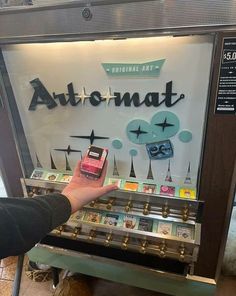 a person is touching an item in front of a sign that says autonatt