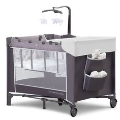 a baby crib with an infant bed attached to the side and wheels on each side