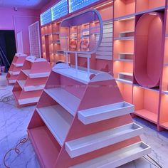 pink shelves with mirrors and lights in a room