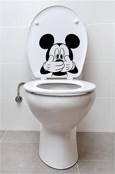 a toilet with a mickey mouse sticker on the lid