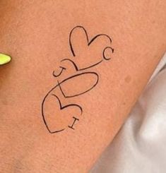 a woman's arm with a tattoo on it that says love and two hearts