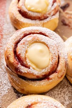 powdered sugar covered pastries with icing on top