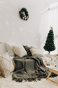 a bedroom with white walls and christmas decorations