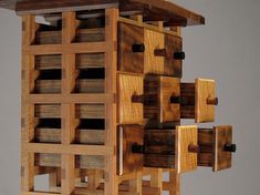 a wooden structure made out of multiple pieces of wood with holes in the top and bottom