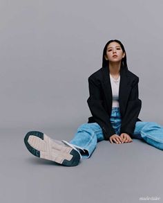 a woman sitting on the floor with her legs crossed