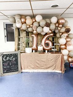 the table is set up with balloons and a sign that says,'6th birthday '