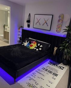 a bed that has some pillows on top of it in a room with purple lighting