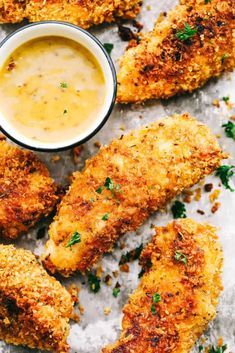 fried chicken with dipping sauce and parsley sprinkled on the side, ready to be eaten