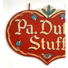 a red sign that says pa - dut stuff with birds and flowers on it