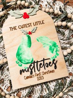 a wooden ornament that says the cute little mistetos