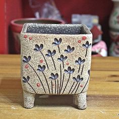 a small planter sitting on top of a wooden table