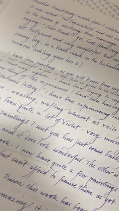 an old handwritten letter is laying on top of a piece of paper with blue ink