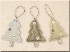 three christmas tree ornaments hanging from strings