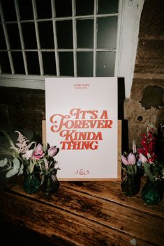 there is a sign that says it's a forever kinda thing next to some flowers