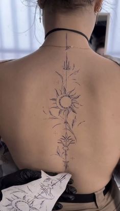 a woman with a tattoo on her back