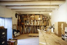 a room filled with lots of wooden boxes and stacks of books on top of shelves