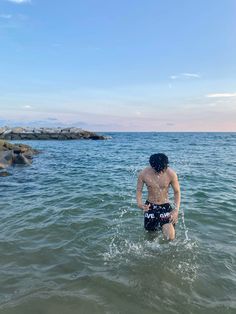 a man is wading in the ocean water