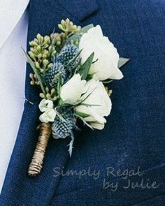 a boutonniere with white flowers and greenery is worn on a man's lapel