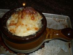 a bowl filled with food sitting on top of a pan