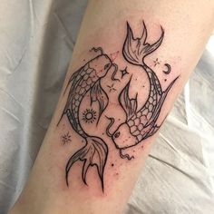 a couple of fish sitting on top of a person's leg with their hands in the air