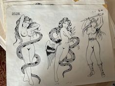 three drawings of women in bodysuits are hanging on a piece of white paper