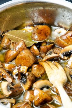 mushrooms are being cooked in a pan on the stove