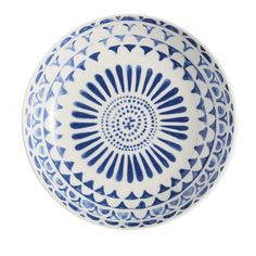 a blue and white bowl sitting on top of a table