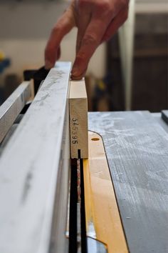 a person is working on a piece of wood that has been cut into smaller pieces