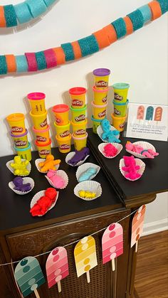 an ice cream stand with cupcakes and candy bars on it