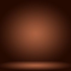 a dark brown background with some light coming from the top and one corner to the bottom