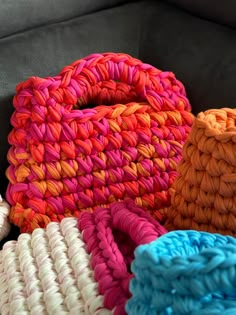 multicolored baskets sitting on top of a couch