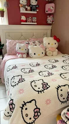 a bedroom with hello kitty bedding and pink walls