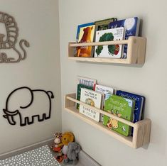 two wooden bookshelves on the wall in a child's room