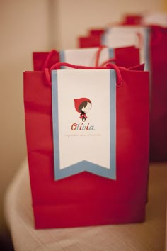 red and white bags with blue trim sitting on a table