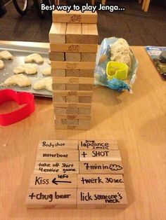 a stack of wooden blocks sitting on top of a table next to doughnuts