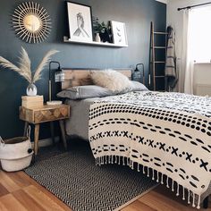 a bed room with a neatly made bed and pictures on the wall