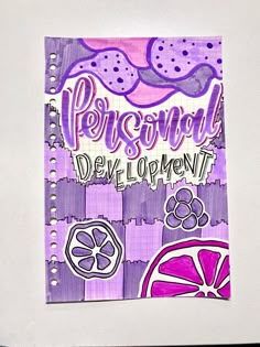 a notebook with the words personal development written in purple and pink on top of it