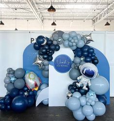 an astronaut balloon arch with balloons and stars