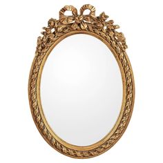 an ornate gold framed mirror with flowers on it's sides and leaves around the edges