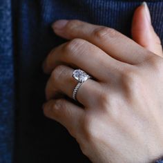 a woman's hand with a diamond ring on it