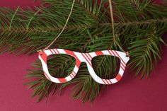 This cute glasses Christmas Ornament is covered in candy stripe. It is cut from 1/8inch thick acrylic.  DETAILS: ~Design is sublimated onto the surface of the acrylic. ~White acrylic core. ~They are about 3 inches wide. ~Option to order a single ornament or as a set.  ~Check out our shop for more Optometry themed items. ~Follow us on Instagram @eyepowerkids for sales and giveaways.  Shipping times may very for international orders. Please Watch our processing times. Processing times  very depend Cute Glasses, Candy Stripes, White Acrylic, White Acrylics, Cat Eye Sunglasses, Cute Gifts, Christmas Ornament, Ornament Decor, Etsy Accessories