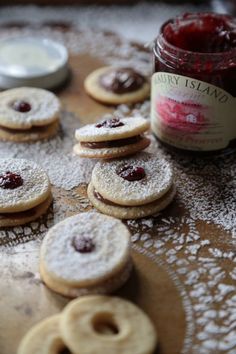 some cookies and jam are on a table