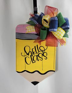 a pencil with a bow hanging from it's side and the words hello class on it